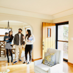 A family tours a bright and spacious home with a real estate agent.