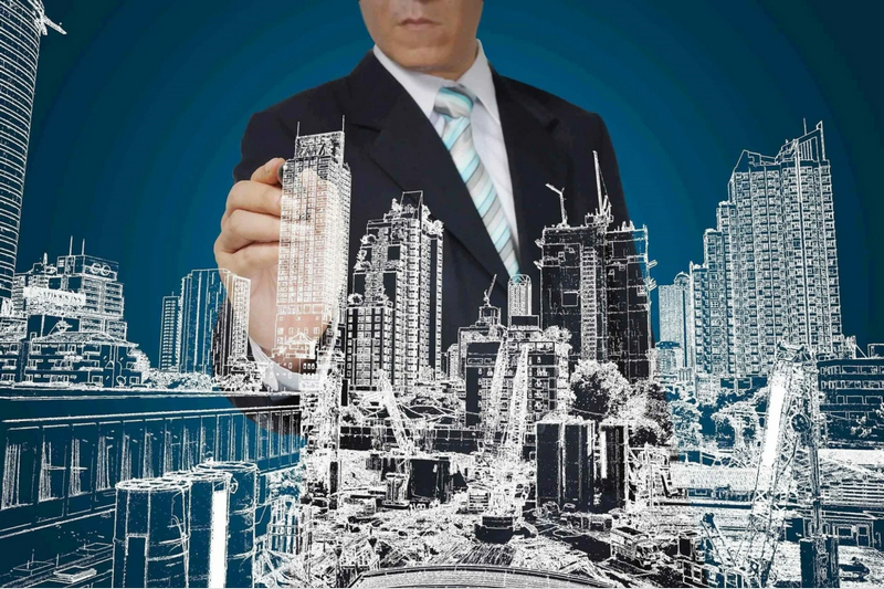 A businessman in a suit appears to be drawing or designing a cityscape using a digital interface.